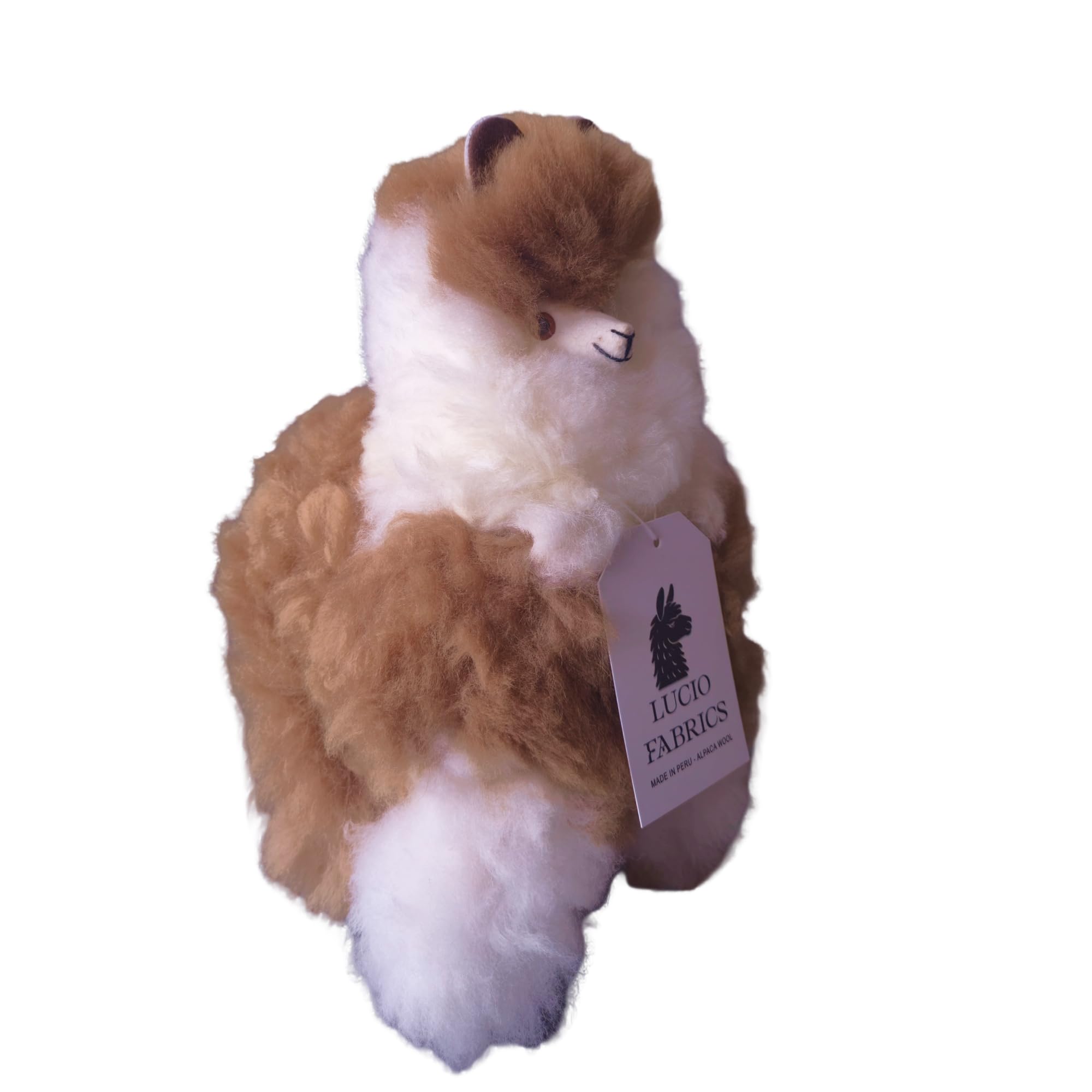 Plush alpaca toy with a Lucio Fabrics tag on a white background