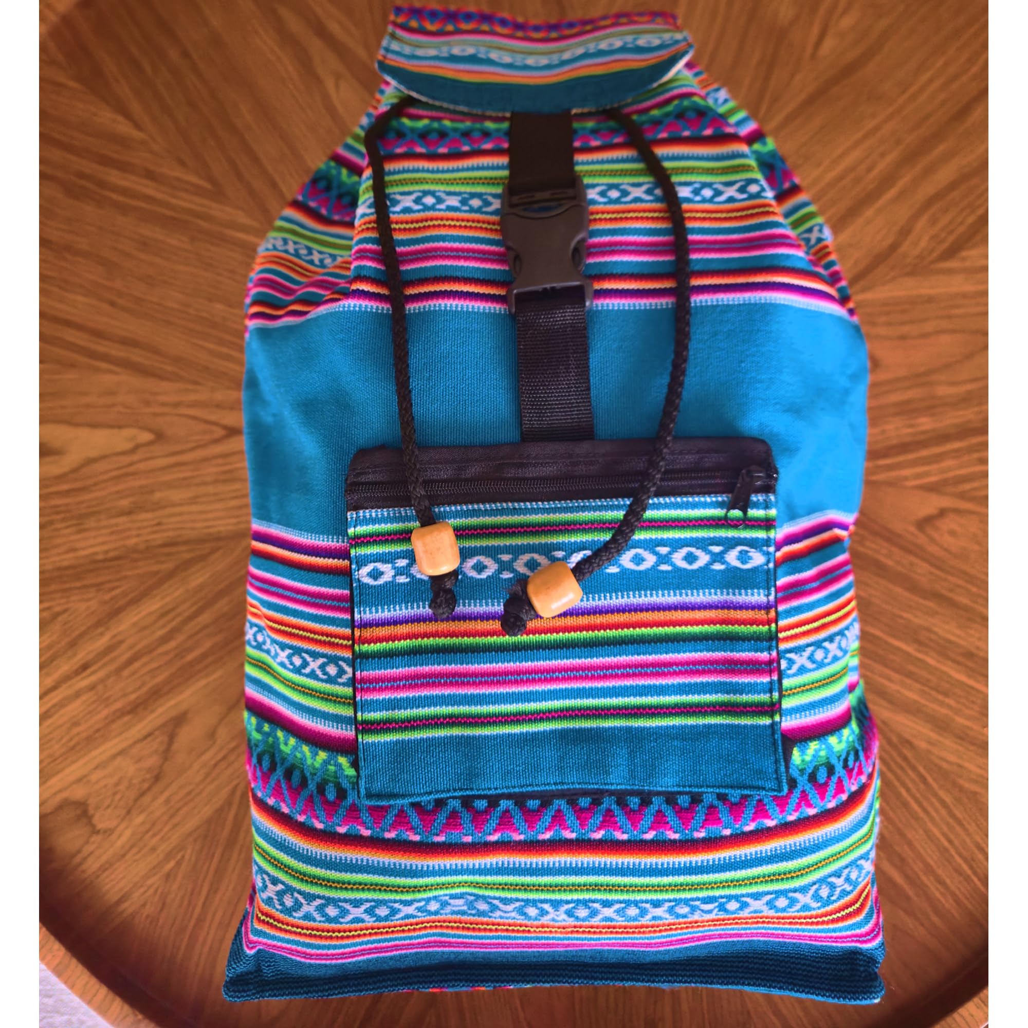 Colorful striped bag with a blue base on a wooden surface