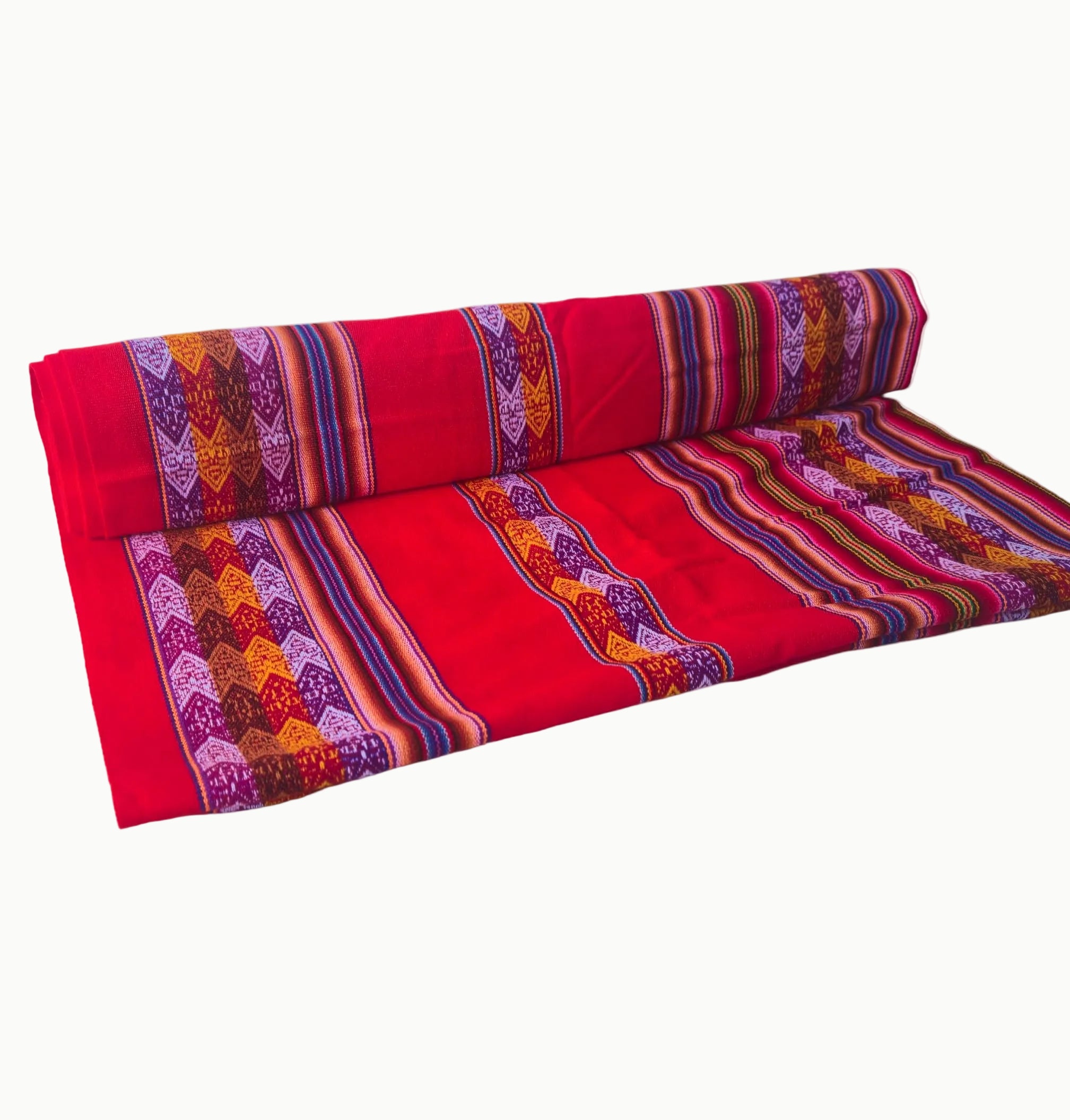 Red fabric with colorful patterns rolled up on a white background