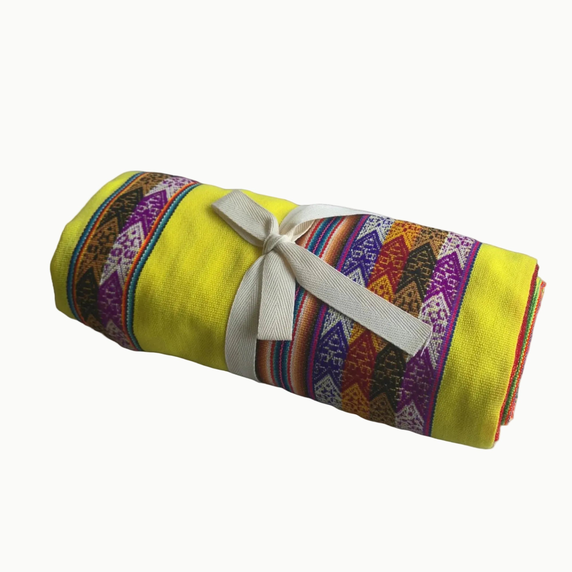 Colorful patterned blanket with a yellow background on a white background