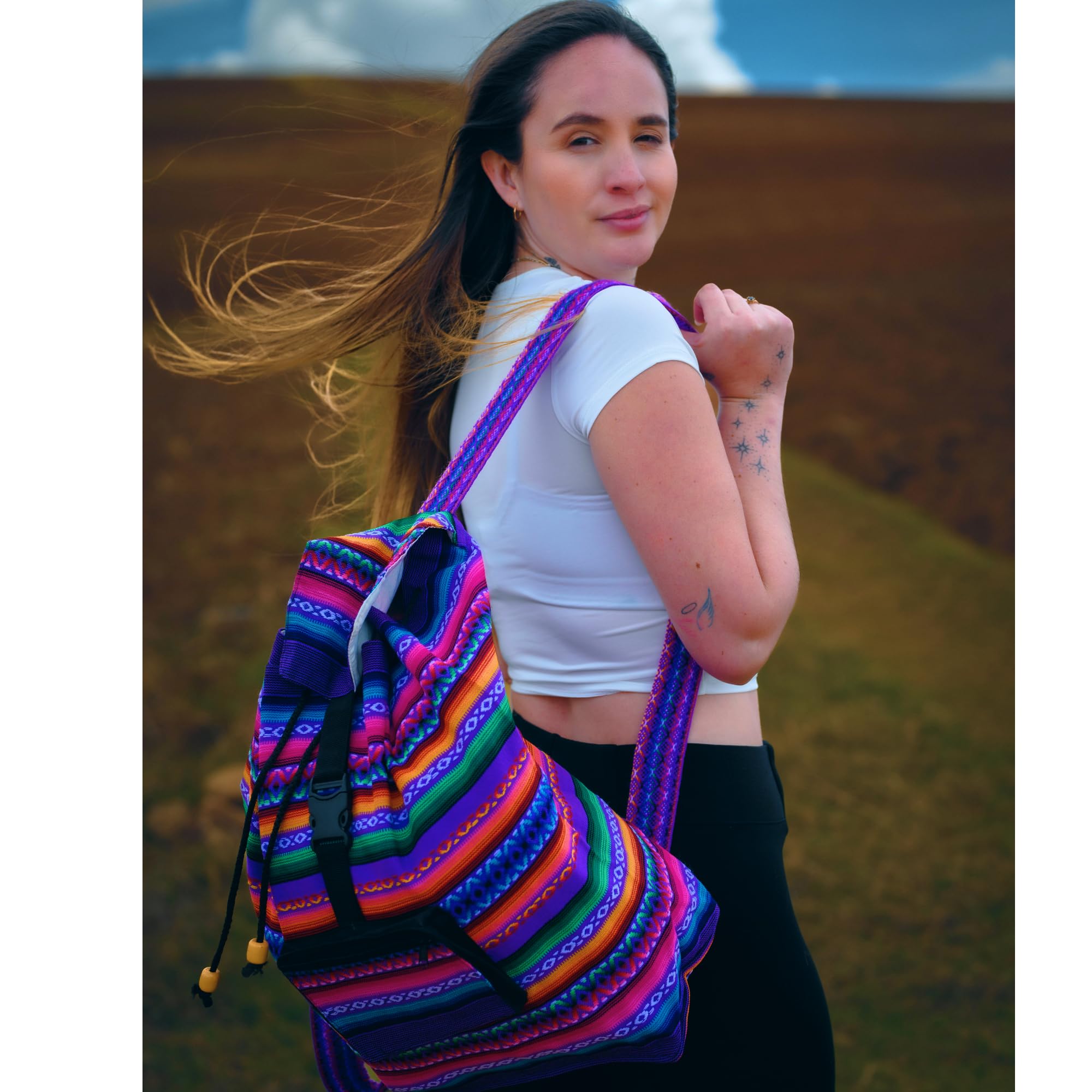 Woman with a colorful backpack standing in a natural landscape