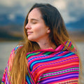 Woman wearing a colorful striped shawl with a blurred background