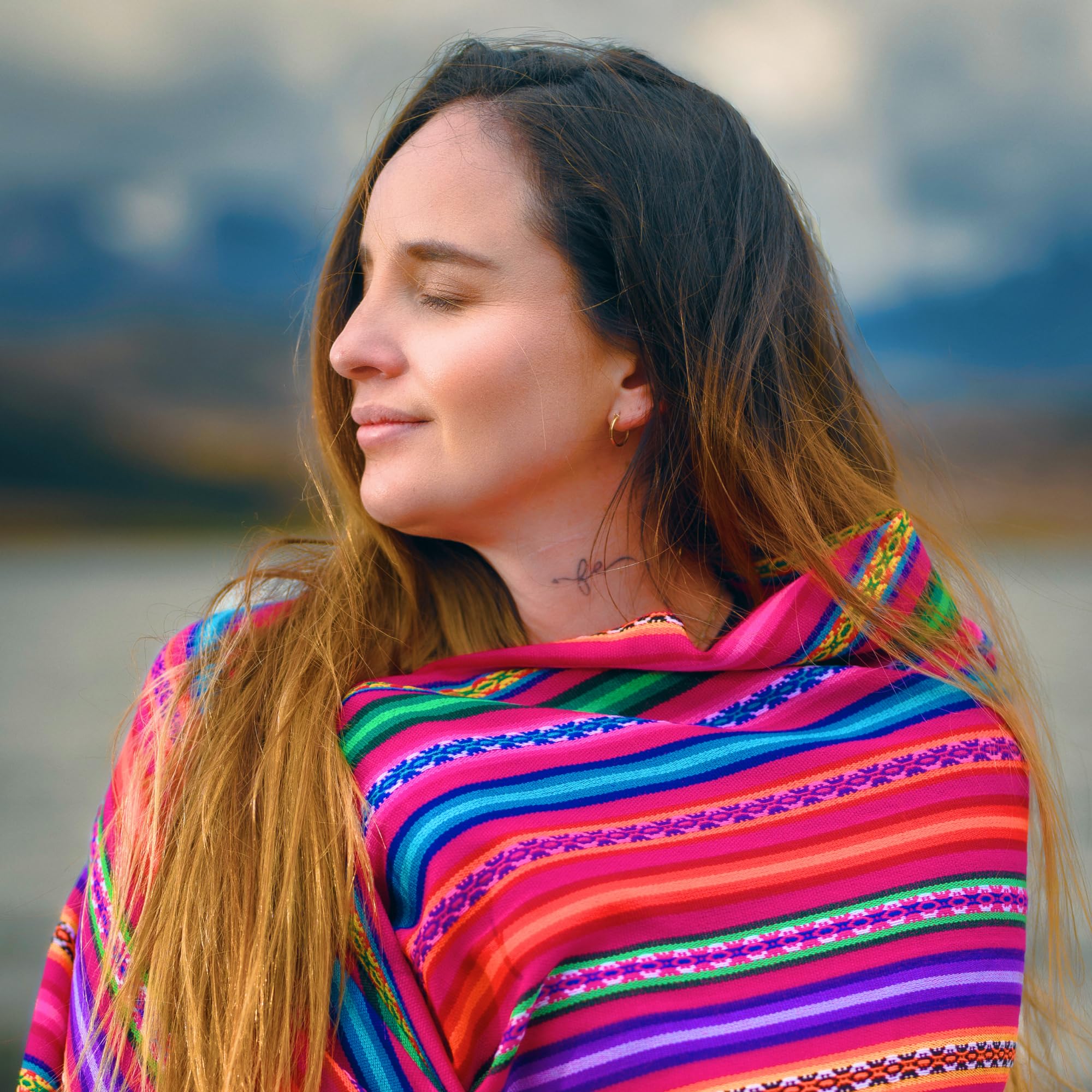 Woman wearing a colorful striped shawl with a blurred background