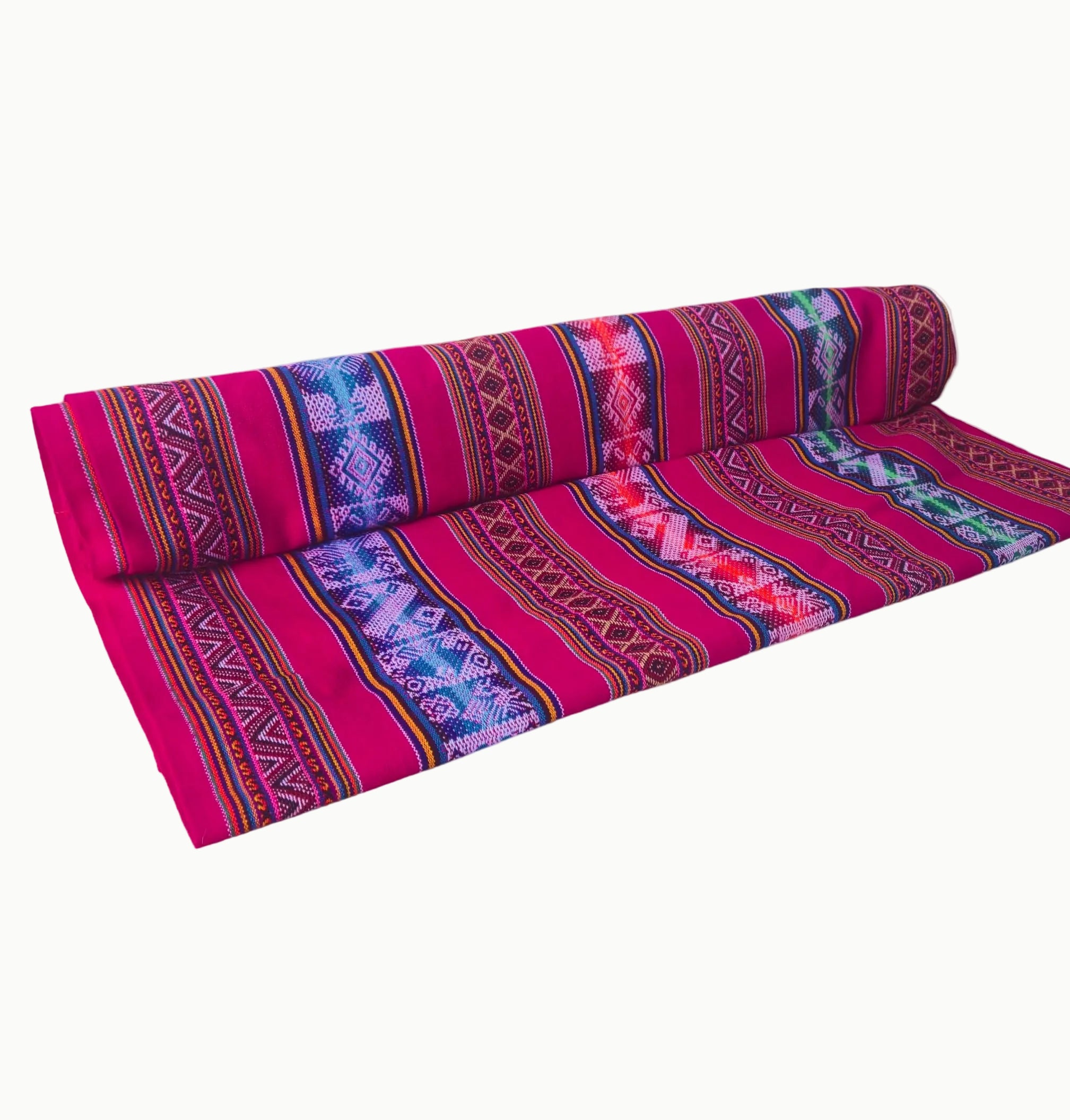 Roll of pink fabric with tribal patterns on a white background