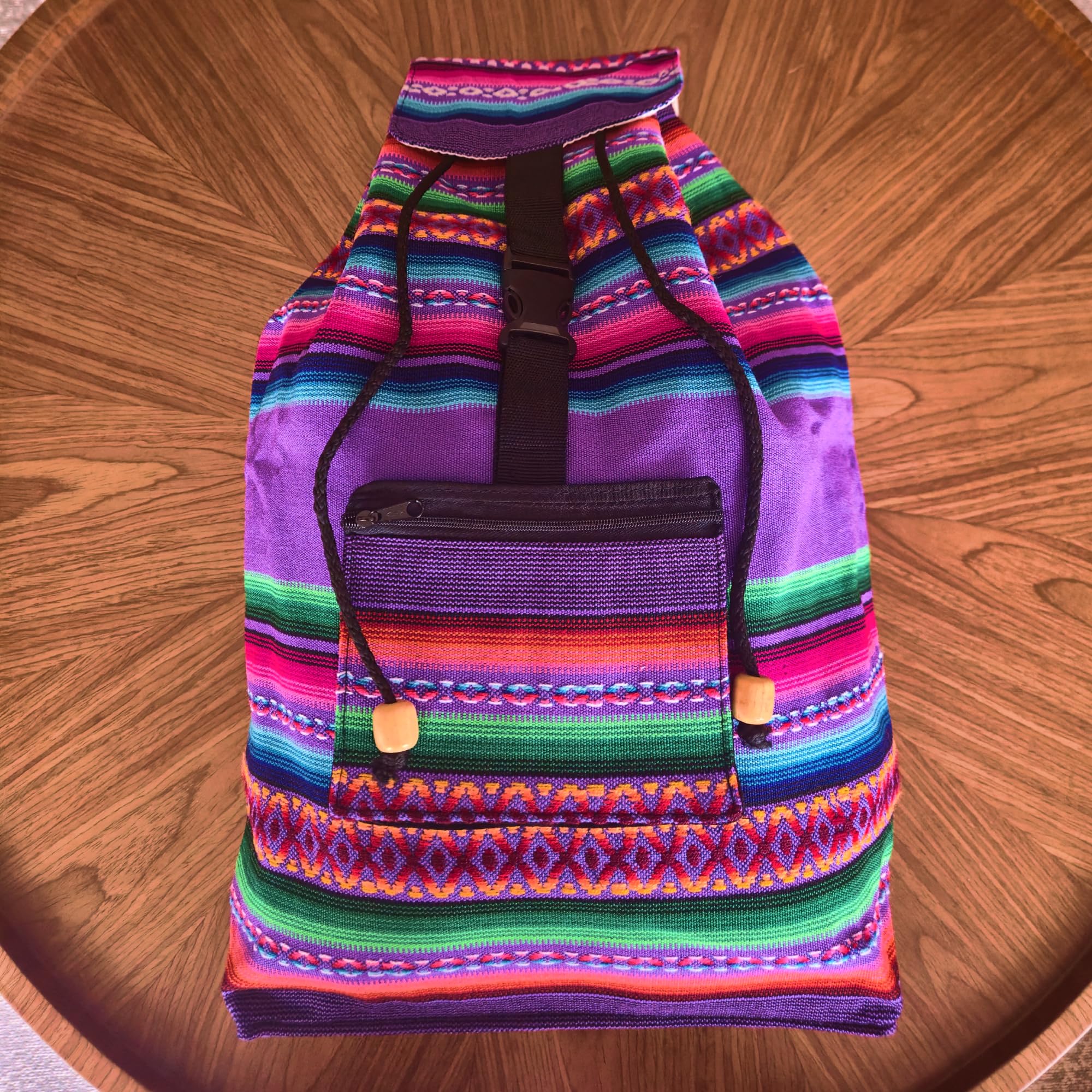 Colorful striped backpack on a wooden surface