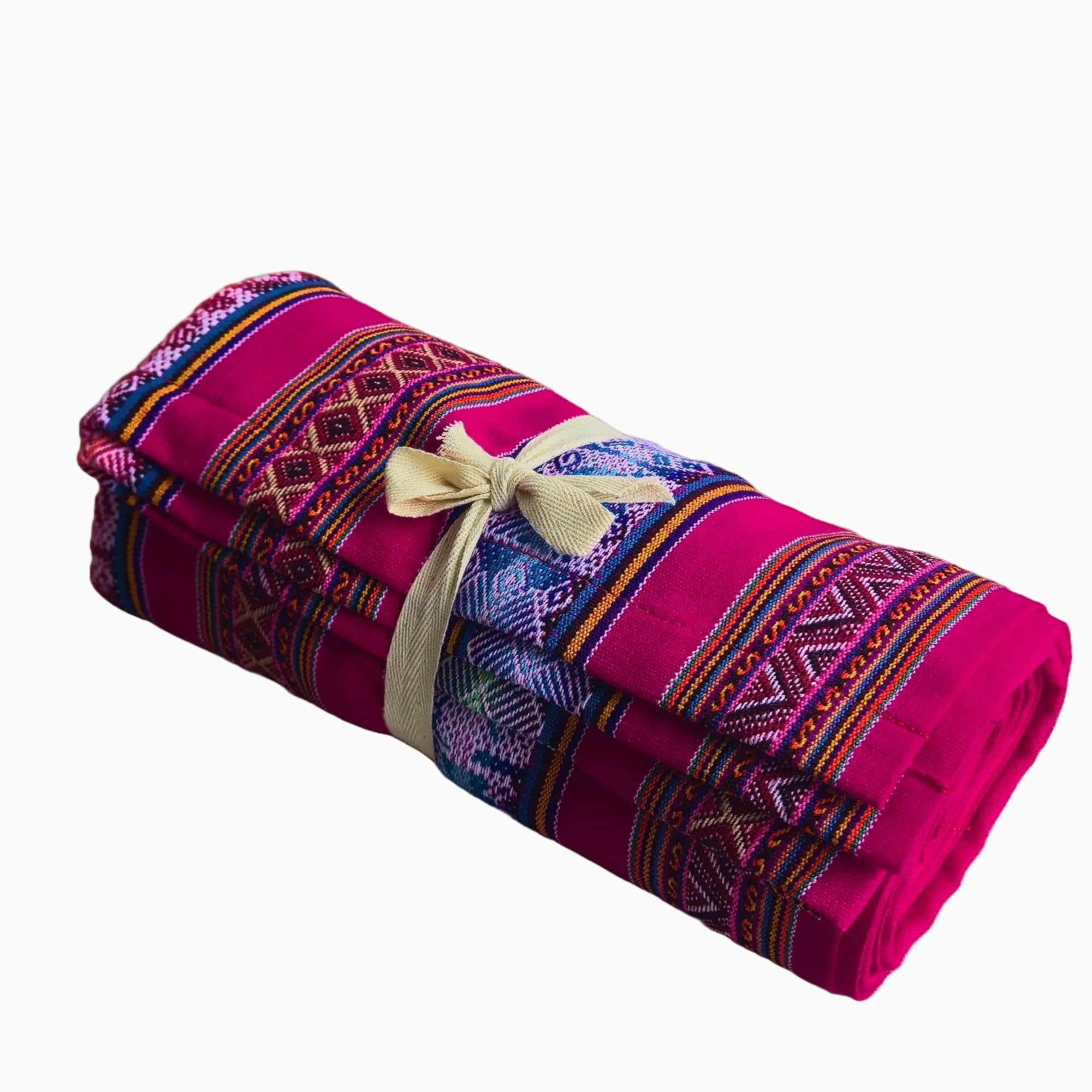 Rolled-up pink blanket with colorful patterns and a yellow ribbon on a white background